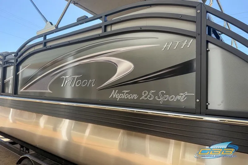 Slide: The Image of 2026 JC 25 Neptoon LG pontoon boat on trailer, featuring sleek design and sturdy ladder. - 47