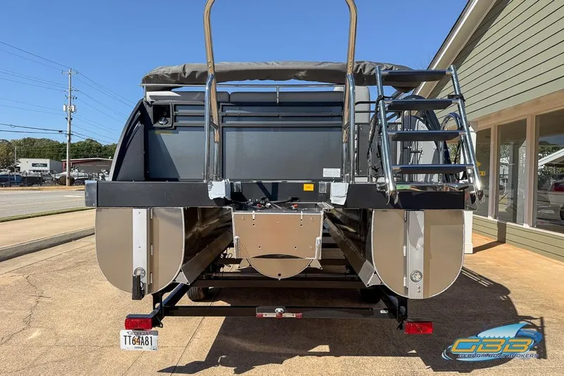 Slide: The Image of 2026 JC 25 Neptoon LG pontoon boat on trailer, parked outdoors. - 50