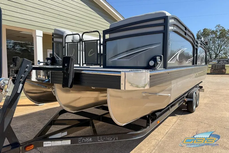 Slide: The Image of 2026 JC 25 Neptoon LG pontoon boat on trailer, parked outdoors. - 51