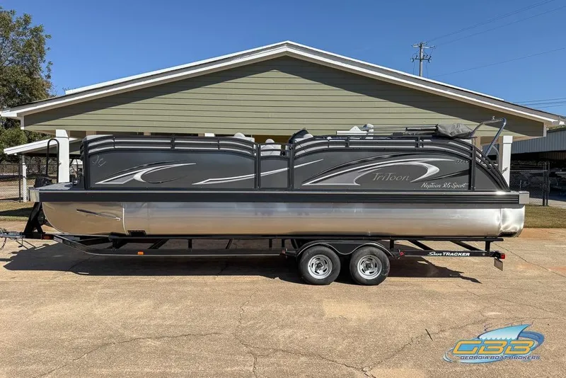 Slide: The Image of 2026 JC 25 Neptoon LG pontoon boat on trailer, parked outdoors. - 54