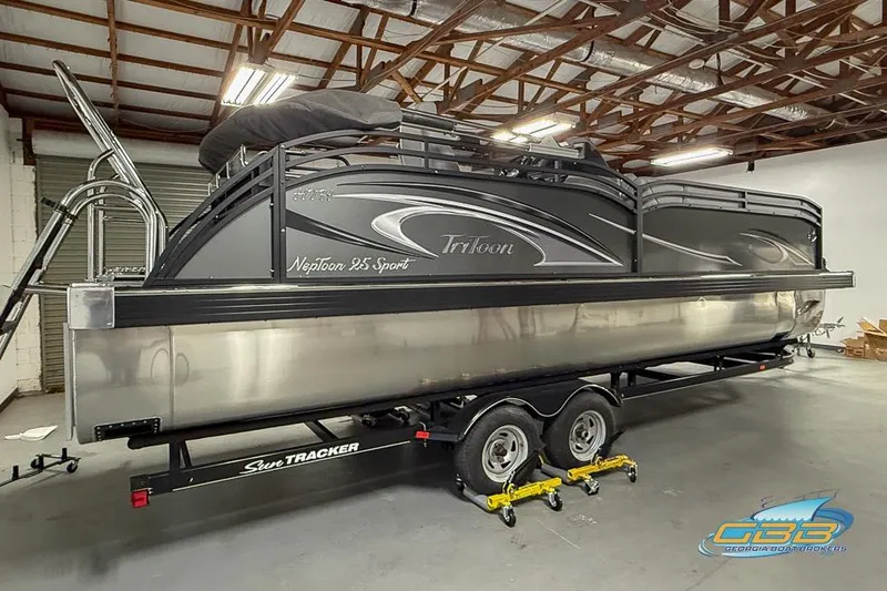 Slide: The Image of 2026 JC 25 Neptoon LG pontoon boat on trailer in warehouse setting. - 58