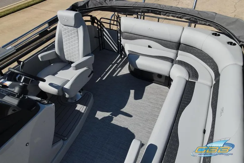 Slide: The Image of 2026 JC 25 Neptoon LG pontoon boat on trailer, parked near building. - 8