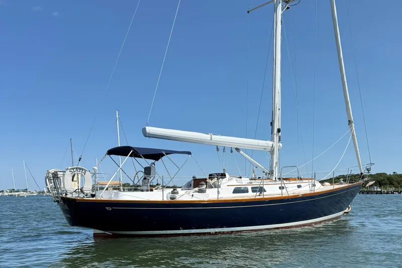 The Image of 1994 Hinckley Sou'wester 42 Sloop sailing yacht on calm water under clear blue sky. - 0