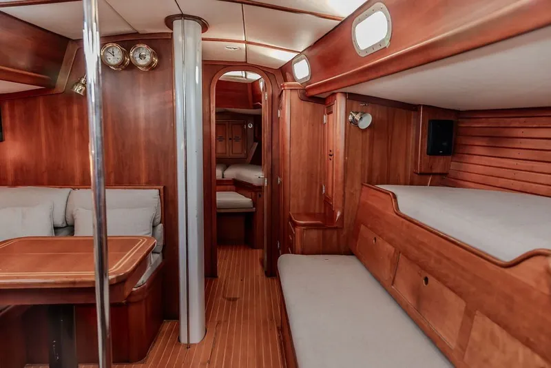 Slide: The Image of Interior of 1994 Hinckley Sou'wester 42 sailboat with wooden furnishings and cozy seating. - 18