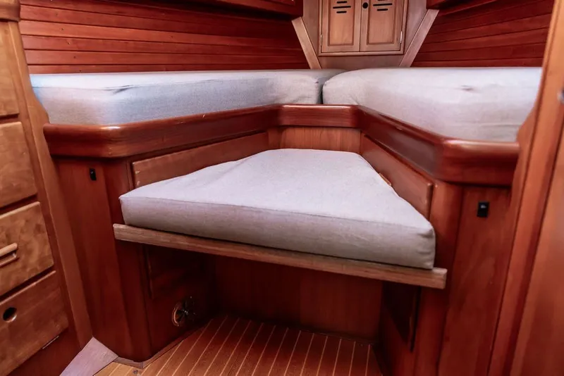 Slide: The Image of Interior cabin of 1994 Hinckley Sou'wester 42 sailboat with wooden finish and cushioned seating. - 23