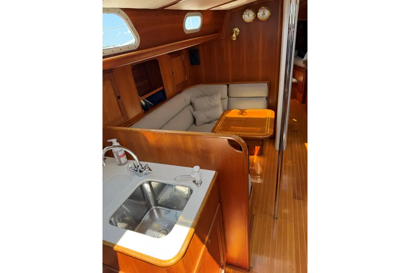 Slide: The Image of Interior of 1994 Hinckley Sou'wester 42 Sloop with wooden finish and cozy seating area. - 3