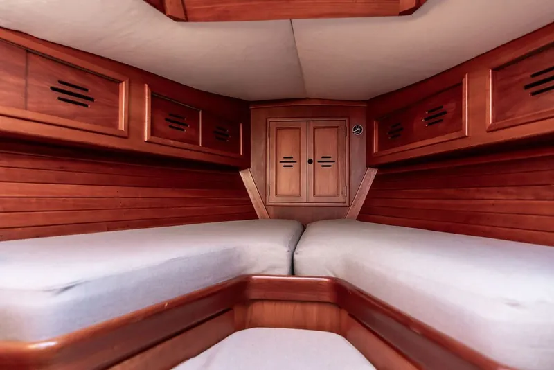 Slide: The Image of Interior cabin of 1994 Hinckley Sou'wester 42 sailboat with wooden finish and cozy bedding. - 22