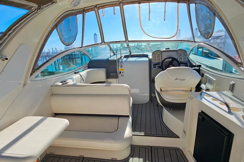 Slide: The Image of Interior of 2006 Cruisers Yachts 300 Express, featuring helm and seating area. - 17