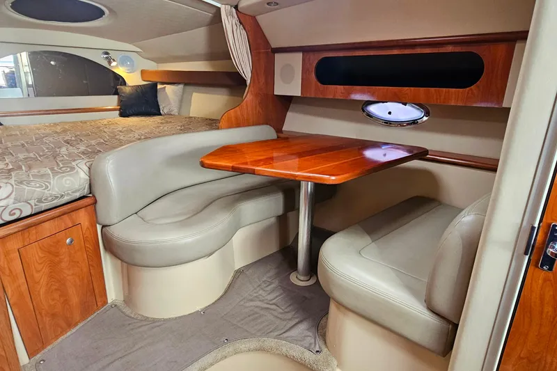 Slide: The Image of Interior cabin of 2006 Cruisers Yachts 300 Express, featuring a cozy bed and elegant design. - 20