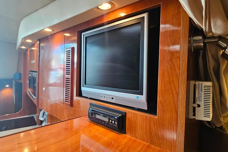 Slide: The Image of 2006 Cruisers Yachts 300 Express interior with cozy seating and wooden table. - 29