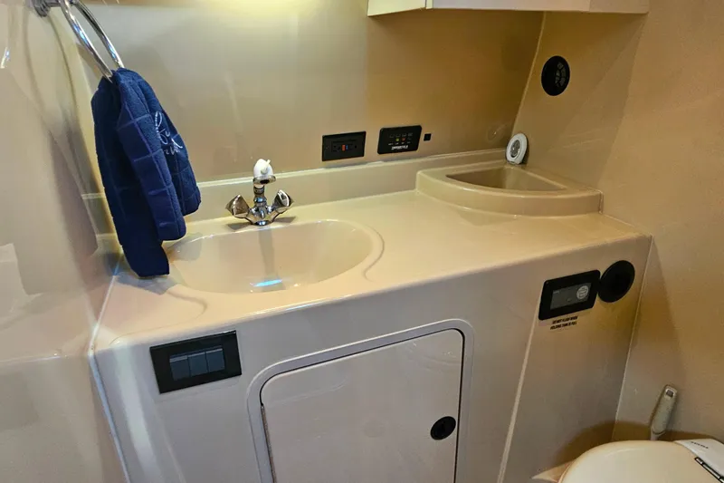 Slide: The Image of 2006 Cruisers Yachts 300 Express bathroom with sink, mirror, and toilet. - 31