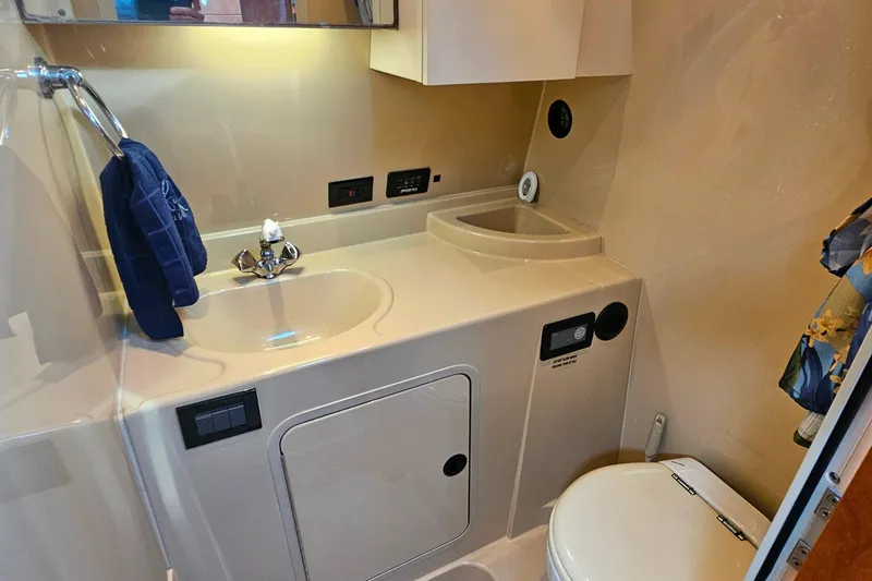 Slide: The Image of Electrical control panel of 2006 Cruisers Yachts 300 Express, featuring various switches and gauges. - 32