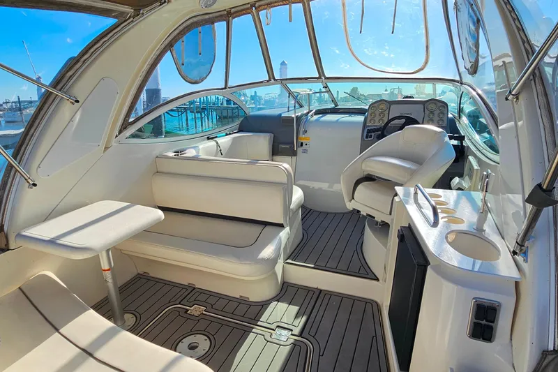 Slide: The Image of Interior view of 2006 Cruisers Yachts 300 Express boat with helm and seating area. - 7