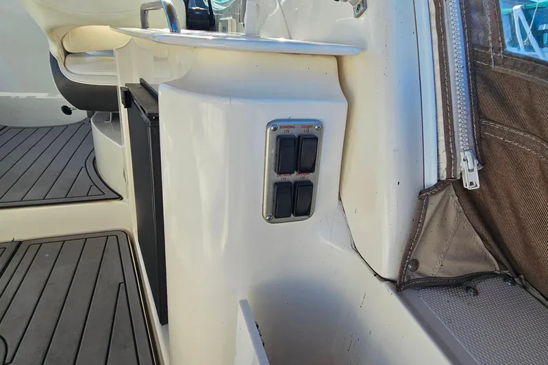 Slide: The Image of 2006 Cruisers Yachts 300 Express helm with gauges and steering wheel. - 13