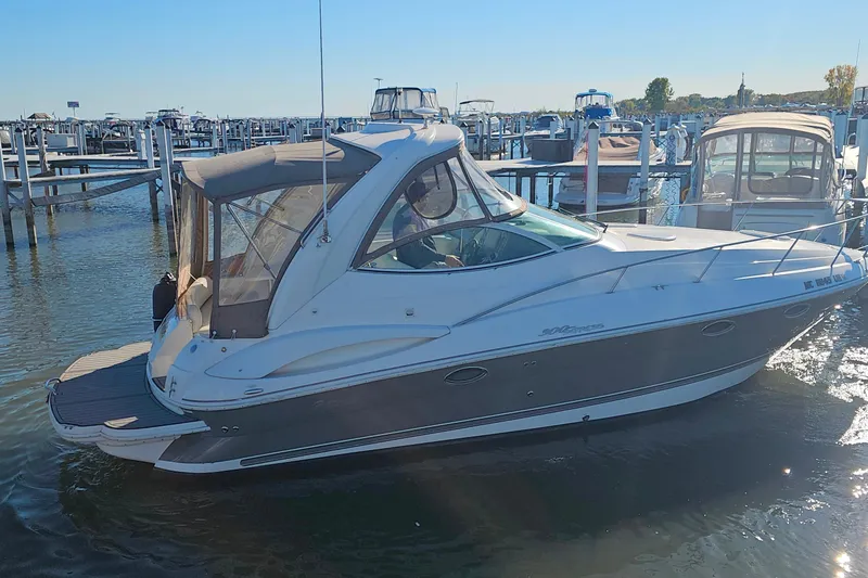 Slide: The Image of 2006 Cruisers Yachts 300 Express docked at marina under clear blue sky. - 2
