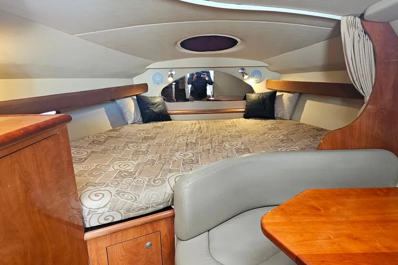 Slide: The Image of 2006 Cruisers Yachts 300 Express interior with kitchenette, microwave, sink, and TV. - 22