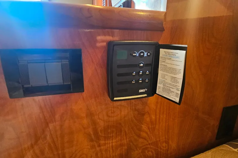 Slide: The Image of 2006 Cruisers Yachts 300 Express interior with built-in TV and wood paneling. - 28