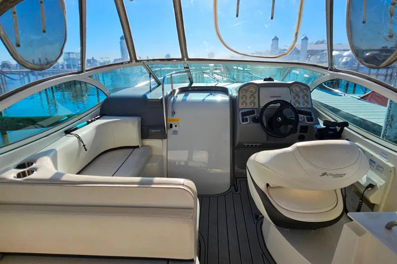 Slide: The Image of 2006 Cruisers Yachts 300 Express interior with seating and table, docked at marina. - 8