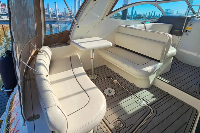 Slide: The Image of 2006 Cruisers Yachts 300 Express interior with white seating and table. - 9
