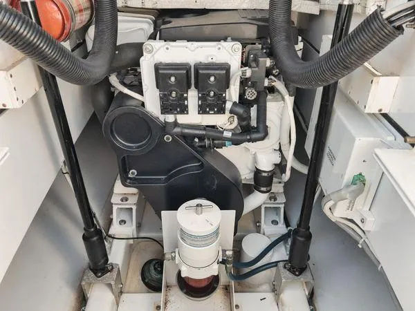 Slide: The Image of Engine compartment of a 2011 Winter Custom Yachts 29, showcasing mechanical components and wiring. - 10
