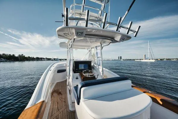 Slide: The Image of 2011 Winter Custom Yachts 29 on calm water, showcasing helm and seating area. - 27
