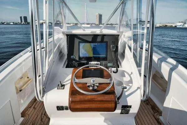 Slide: The Image of Helm of 2011 Winter Custom Yachts 29, featuring navigation equipment and wooden steering wheel. - 29