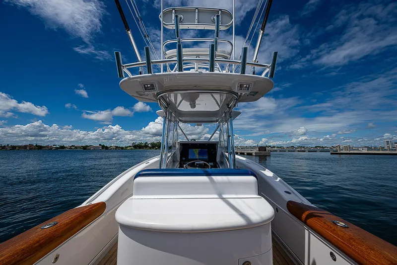 Slide: The Image of 2011 Winter Custom Yachts 29 on water, showcasing helm and tower under clear blue sky. - 6