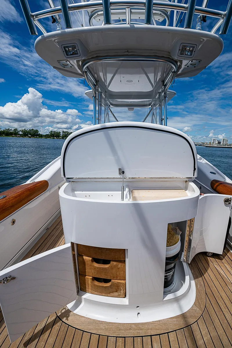 Slide: The Image of 2011 Winter Custom Yachts 29 with open storage, wooden deck, and clear sky background. - 7