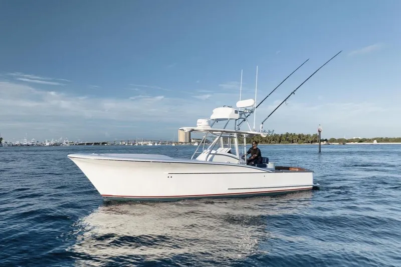 Slide: The Image of 2011 Winter Custom Yachts 29 boat on calm water, clear sky background. - 18