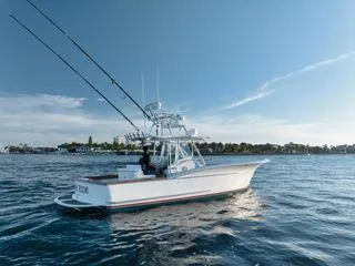 Slide: The Image of 2011 Winter Custom Yachts 29 boat on calm water under clear blue sky. - 19