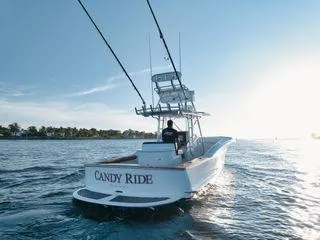 Slide: The Image of 2011 Winter Custom Yachts 29 boat "Candy Ride" cruising on open water at sunset. - 20