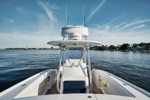 Slide: The Image of 2011 Winter Custom Yachts 29 on calm water, featuring Garmin equipment and clear blue skies. - 22