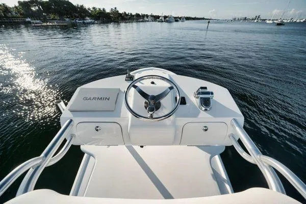 Slide: The Image of Steering console of 2011 Winter Custom Yachts 29 on calm water, featuring Garmin equipment. - 24