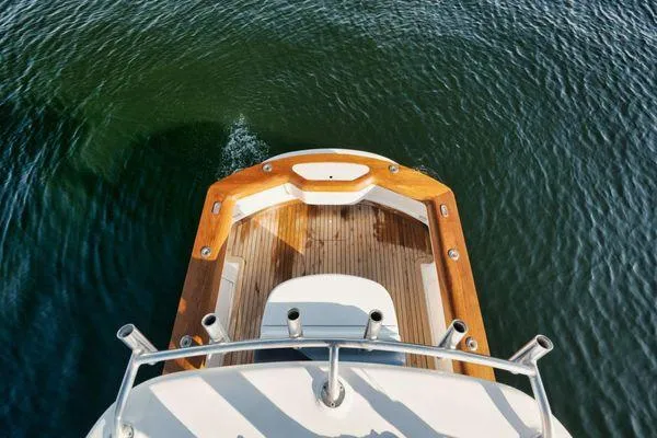 Slide: The Image of 2011 Winter Custom Yachts 29, wooden deck, cruising on calm water. - 25