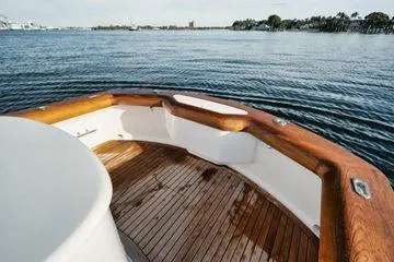 Slide: The Image of 2011 Winter Custom Yachts 29 with wooden deck, overlooking serene water and distant shoreline. - 28