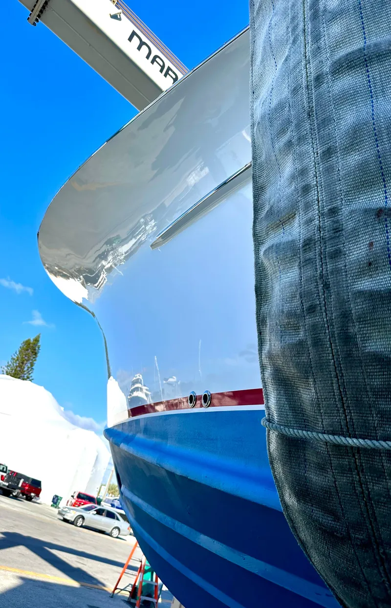 Slide: The Image of 2011 Winter Custom Yachts 29 boat in dry dock, blue hull, sunny day. - 33