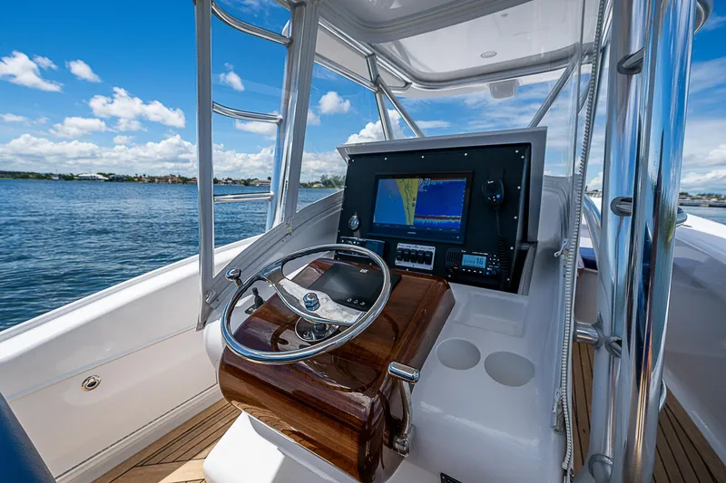 Slide: The Image of 2011 Winter Custom Yachts 29 helm with navigation system, steering wheel, and ocean view. - 5