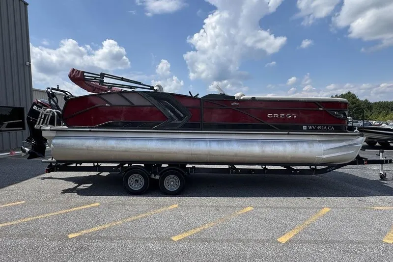 Slide: The Image of 2021 Crest Caribbean Platinum 250 SLS pontoon boat on trailer, parked outdoors. - 11