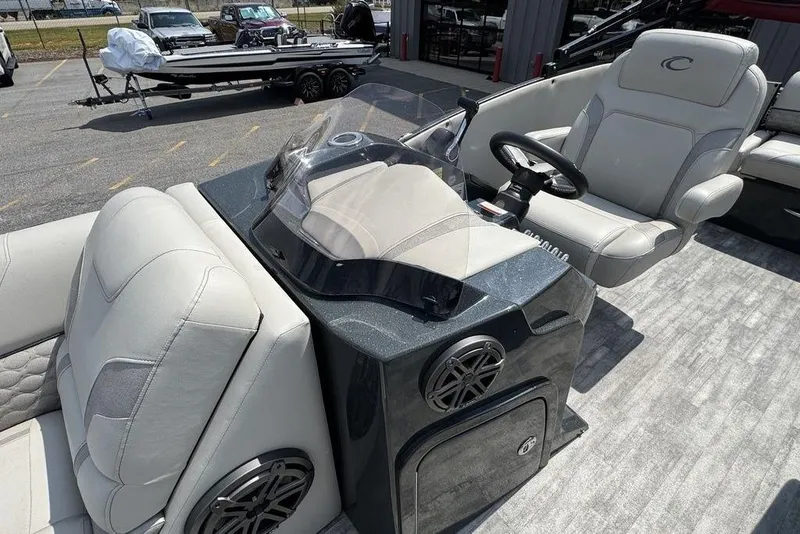 Slide: The Image of 2021 Crest Caribbean Platinum 250 SLS boat interior with plush seating and modern dashboard. - 16