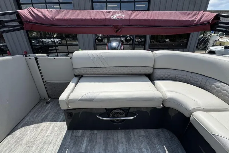 Slide: The Image of 2021 Crest Caribbean Platinum 250 SLS boat interior with plush seating and maroon canopy. - 19