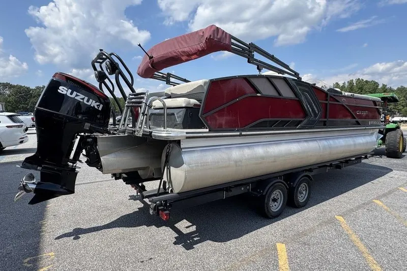 Slide: The Image of 2021 Crest Caribbean Platinum 250 SLS pontoon boat with Suzuki outboard motor on trailer. - 2