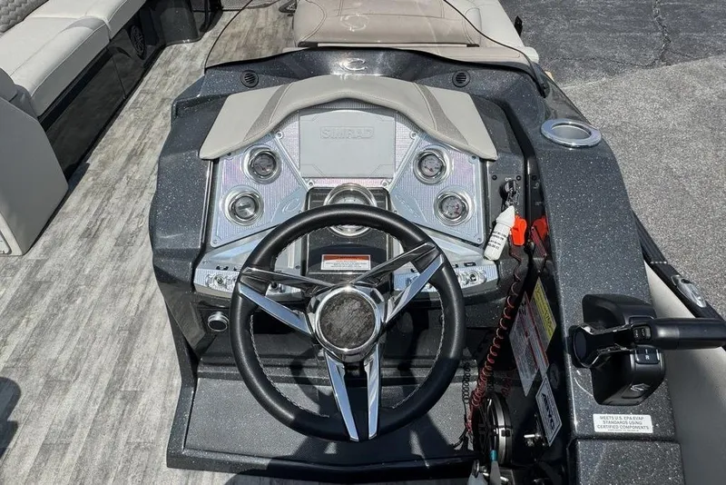 Slide: The Image of 2021 Crest Caribbean Platinum 250 SLS boat dashboard with steering wheel and controls. - 20