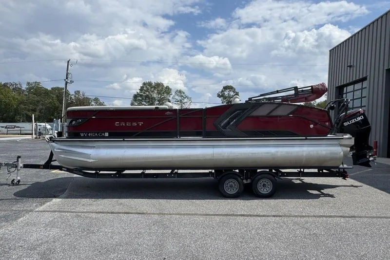 Slide: The Image of 2021 Crest Caribbean Platinum 250 SLS pontoon boat on trailer, parked outdoors. - 5