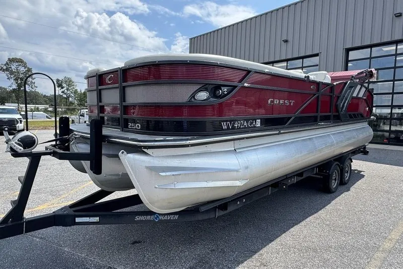 Slide: The Image of 2021 Crest Caribbean Platinum 250 SLS pontoon boat on trailer, parked outdoors. - 7