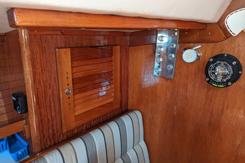 Slide: The Image of Interior of 1993 J Boats J/130, featuring wood paneling and nautical instruments. - 14