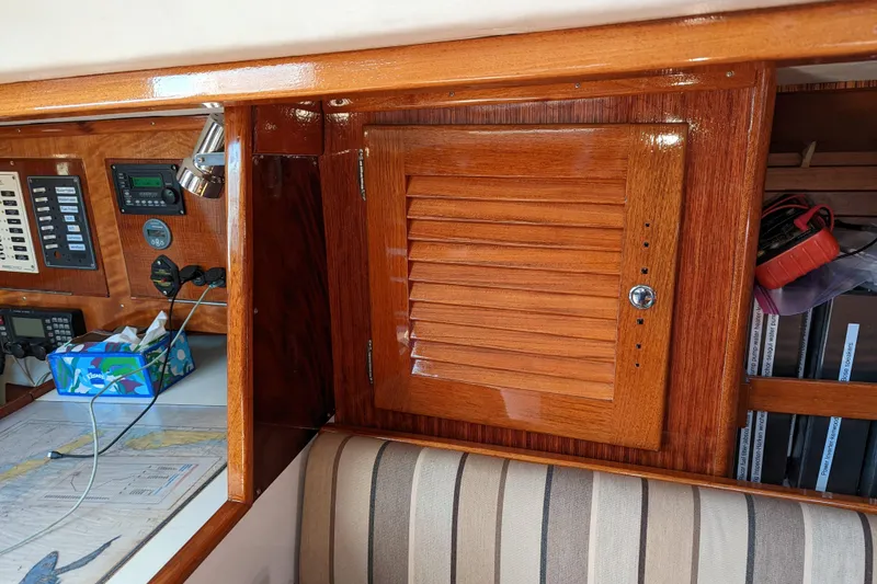 Slide: The Image of Interior of 1993 J Boats J/130, featuring wooden cabinetry and navigation equipment. - 15