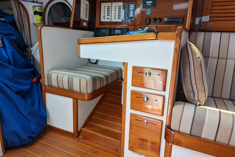 Slide: The Image of Interior of a 1993 J Boats J/130 sailboat with striped seating and wooden cabinetry. - 18
