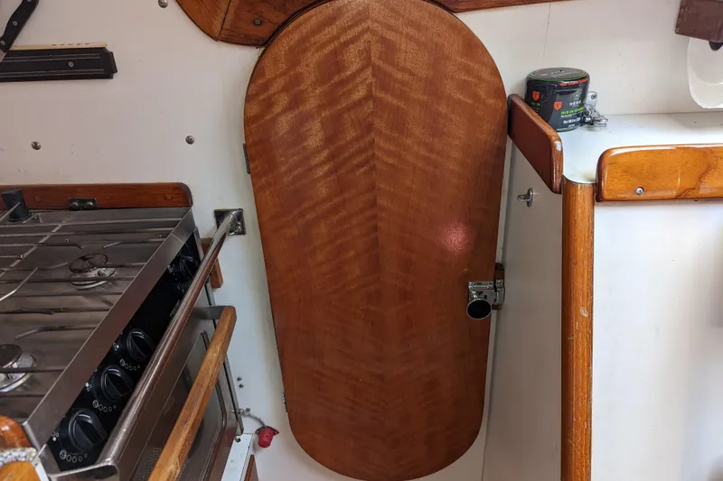 Slide: The Image of Interior of 1993 J Boats J/130 showing wooden cabinetry and stove. - 29