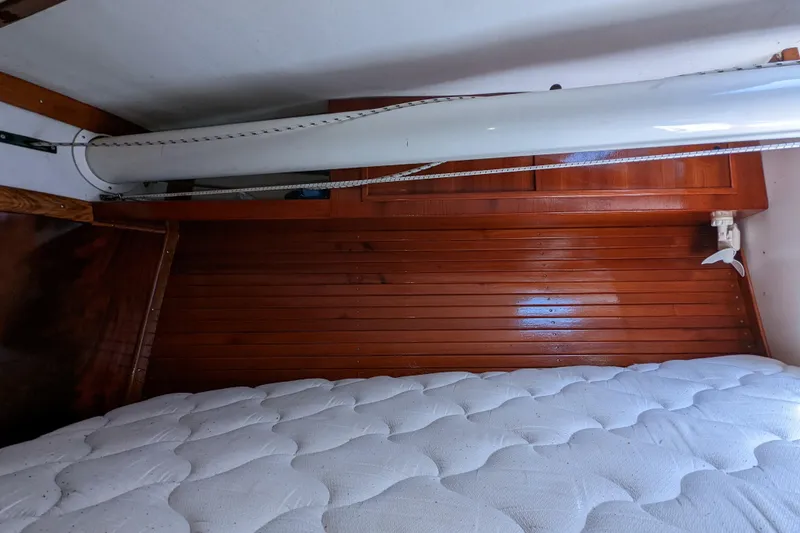 Slide: The Image of Interior cabin of 1993 J Boats J/130 with wooden paneling and mattress. - 33