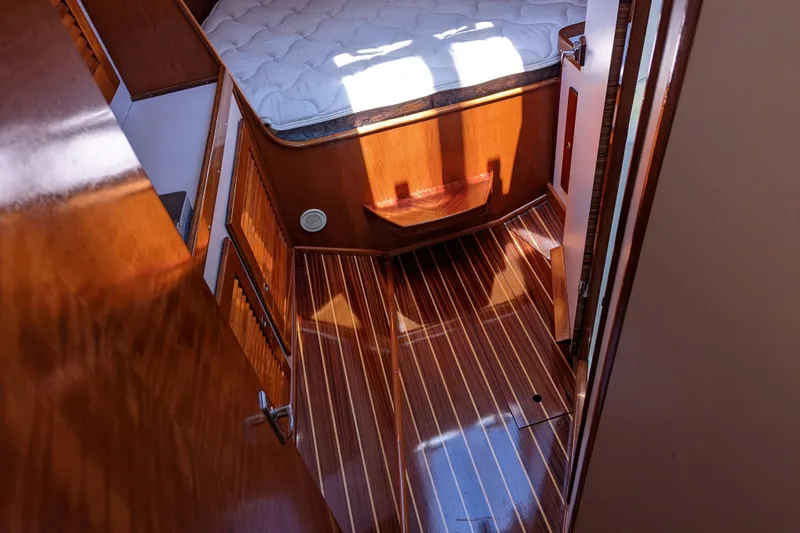 Slide: The Image of Interior of 1993 J Boats J/130, featuring polished wood flooring and cozy cabin space. - 34